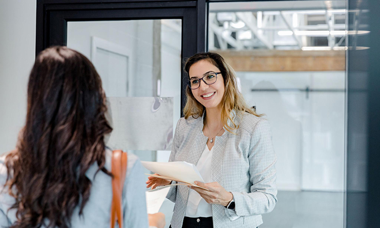 A candid photo where a woman is connecting with someone